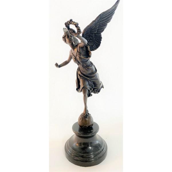 Winged Victory Athena Nike Paris Louvre Bronze Marble: This charming angel stands atop a rock about to fly away as she is about to blow on her horn and on her other hand she holds a halo of leaves. her hand is raised high and her right leg is liftback, sh