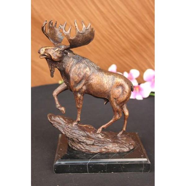 Male Moose Hunting Bronze Sculpture: This is a magnificent Sculpture of a male Moose. You can see he is fully grown due to his large antlers and a predominant bell hanging from his chin. The hair on the back of his neck is longer than th