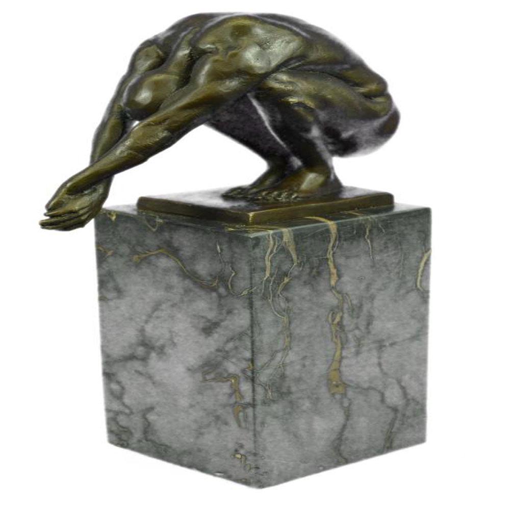Nude Male Bronze Sculpture: This Statue is a conceptual representation of a nude man sitting on top of a platform. He situated with both arms stretched while he leans forward and looks straight downward. He is clearly deep in th