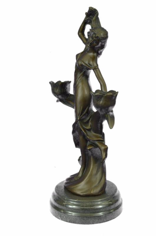Candle Holder Candelabra Bronze Sculpture: This gorgeous candle holder depicts a woman relaxing as she wipes the sweat from her forehead. She places one hand behind her and exudes beauty from her inner being. She is dressed in a gorgeous flowi