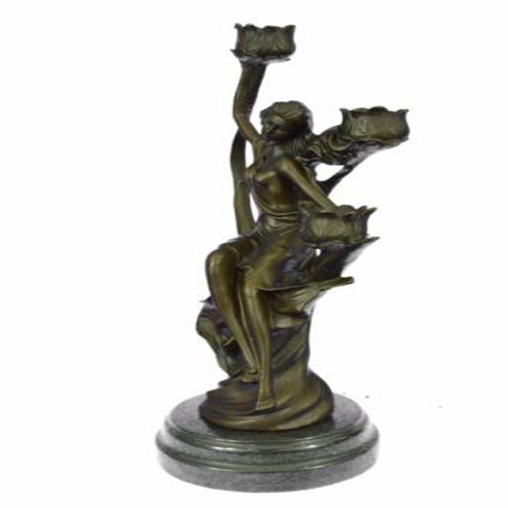 Lady Candelabra Bronze Sculpture: This gorgeous candle holder depicts a woman relaxing as she wipes the sweat from her forehead. She places one hand behind her and exudes beauty from her inner being. She is dressed in a gorgeous flowi