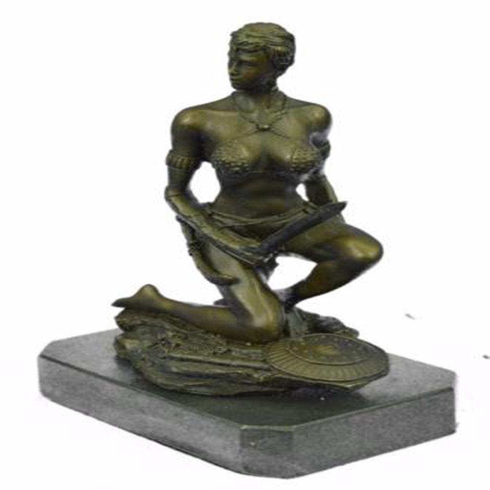 Amazon Woman With Sword Bronze Statue: A sexy and tough Amazon warrior sits proudly holding her sword. Her other arm is tense, highlighting her sculpted arms. Her large breasts are dressed in a studded bikini. She is a fighter in the wild.
