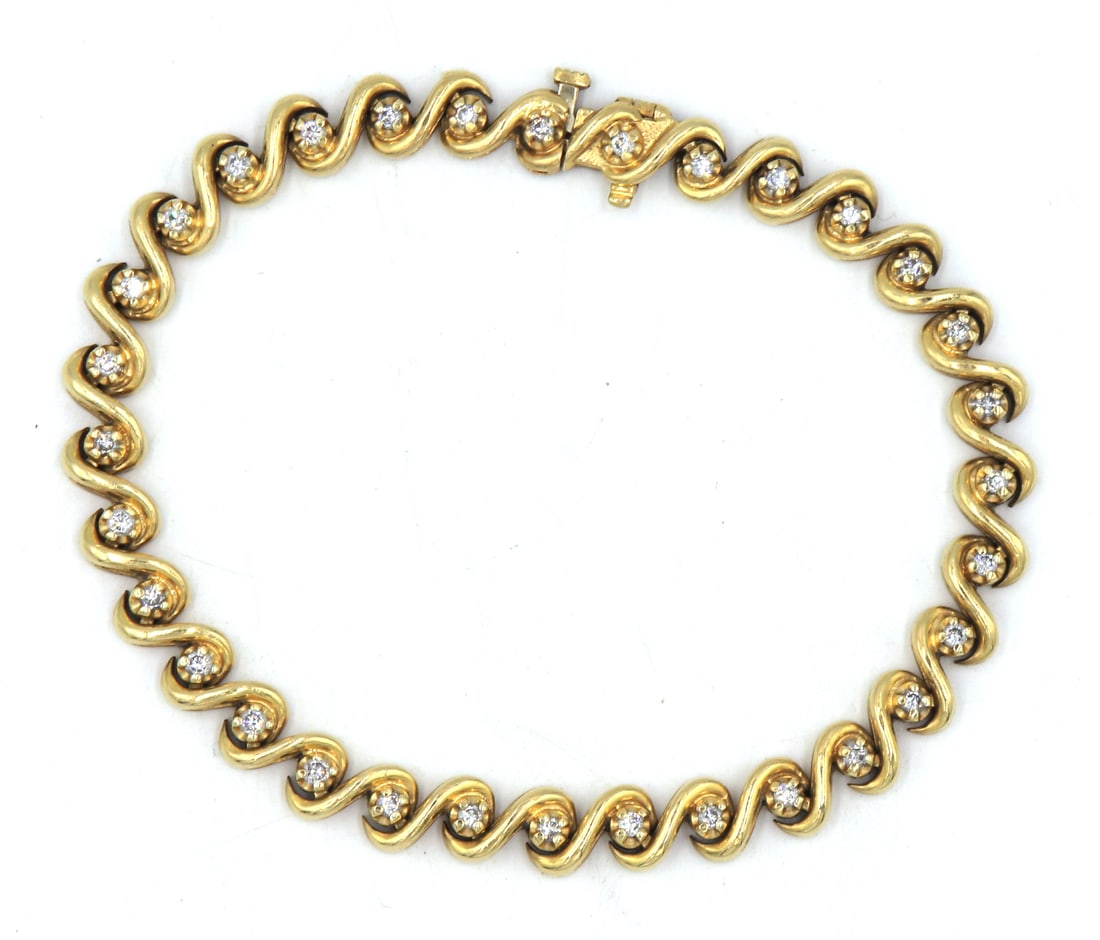 14kt Yellow gold diamond wavy tennis bracelet: 14kt Yellow gold diamond wavy tennis 7.75 inches bracelet. Total weight of bracelet is 25.4 grams.
