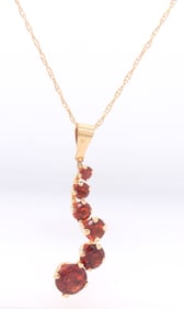 14kt Yellow gold garnet journey pendant on chain necklace