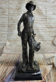 Cowboy with Saddle and Gun Bronze Sculpture