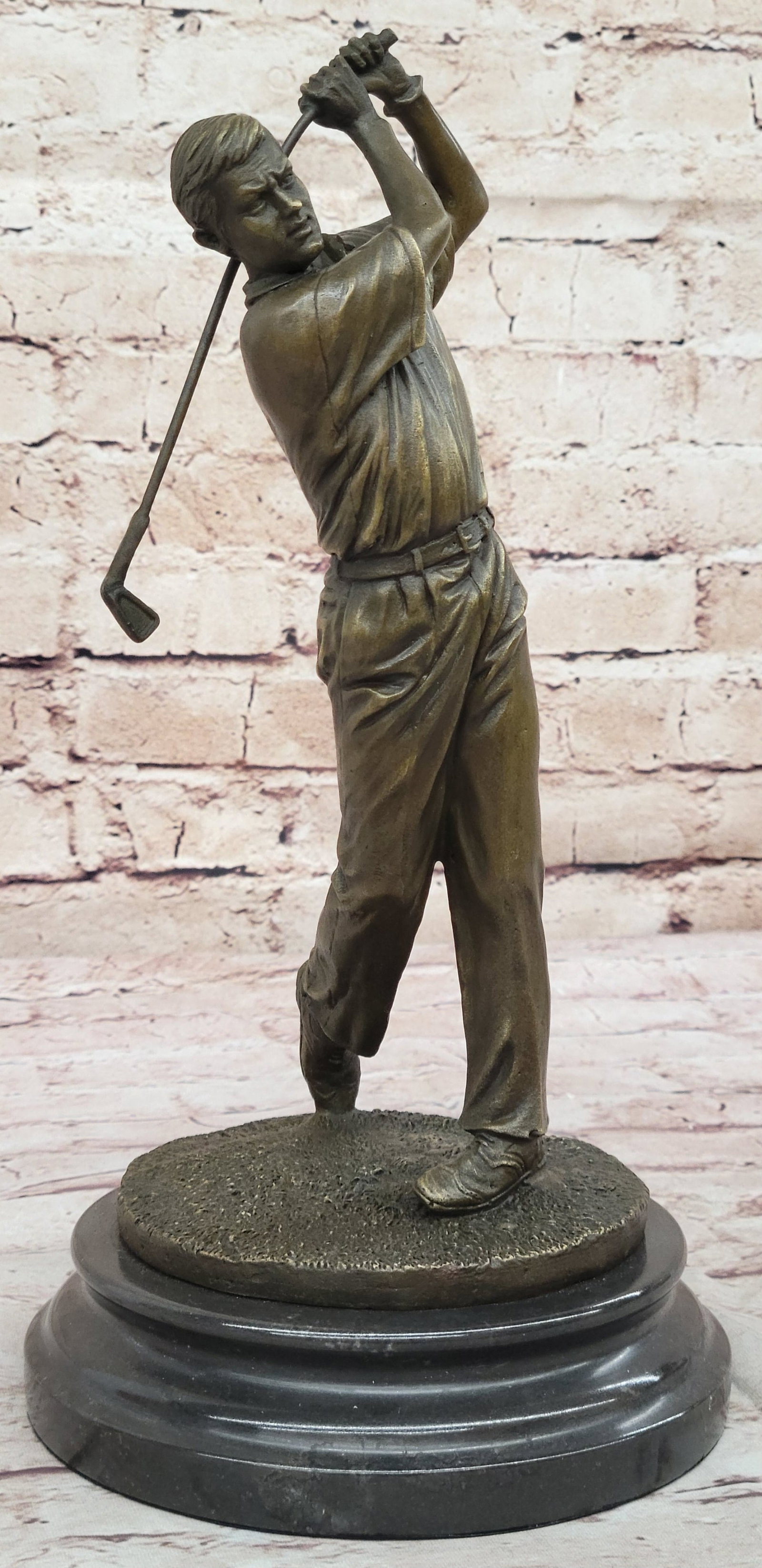 Golfer Bronze Sculpture: He watches his golf ball fly high over the rough and into the green. It is the epitome of the perfect swing. He holds his pose as he watches his ball make its way to the hole. His arms are right-angle