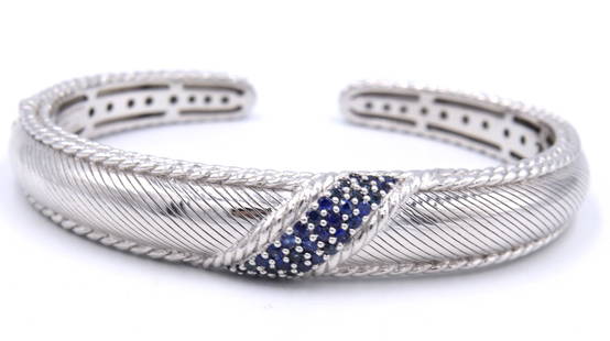 925 Sterling silver Judith Ripka sapphire Hinged bangle: 925 Sterling silver Judith Ripka blue sapphire Hinged bangle. Total weight of bangle 43.1 grams.
