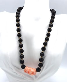 Coral pendant on black onyx beaded necklace