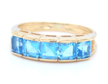 14kt Yellow gold channel set princess cut blue topaz five stone band