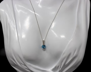 10kt White gold blue topaz and diamond pendant on chain