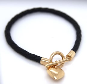 Black cord twisted bracelet with 14kt yellow gold heart shaped charm and toggle clasp