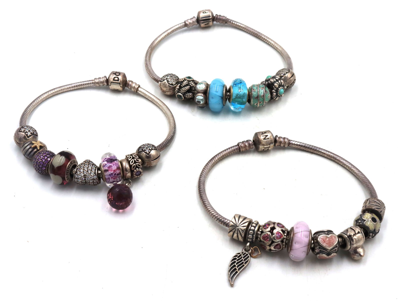 Lot of 3 Pandora charms bracelet in sterling silver: Lot of 3 Pandora charms bracelet in 925 sterling silver. The total weight of the lot is 124.90 grams.