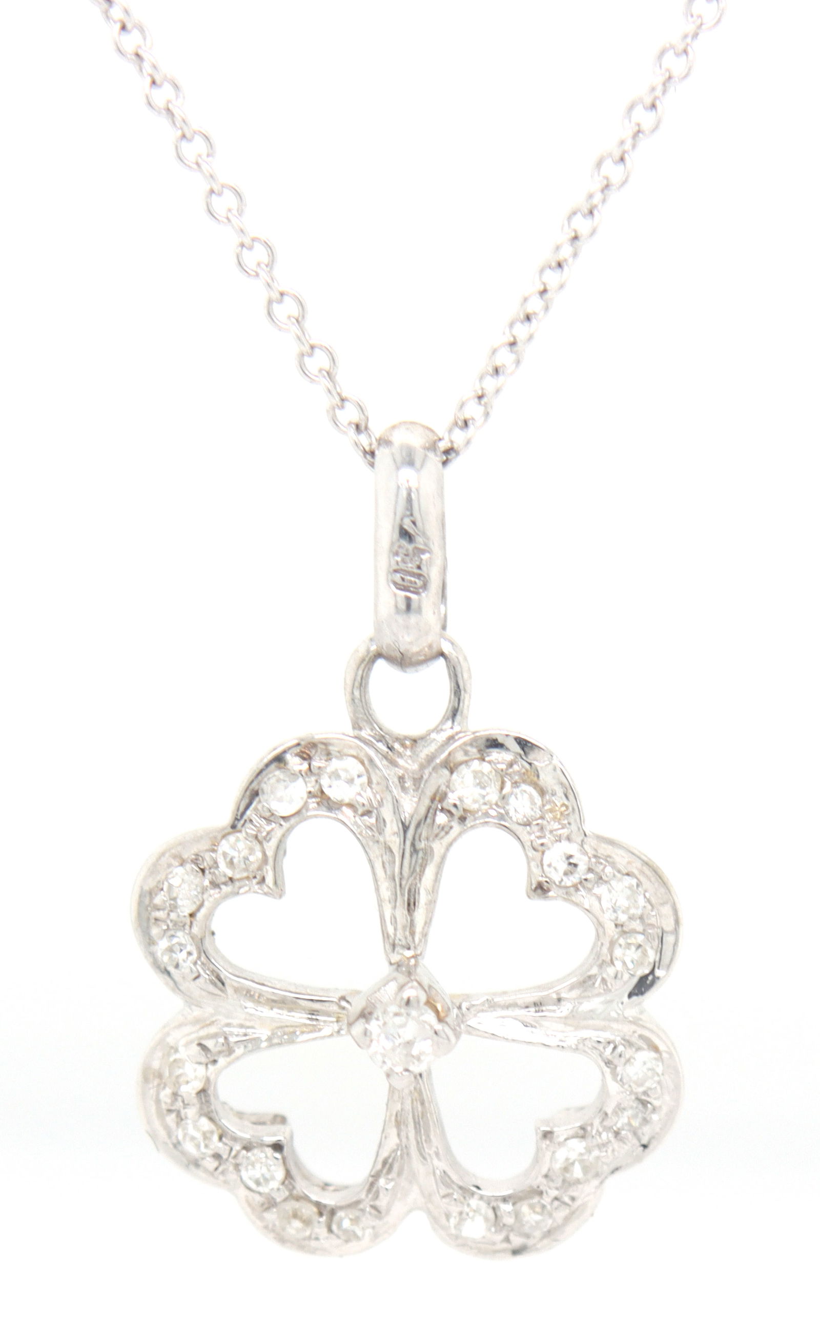 18kt White gold diamond heart clover charm pendant on chain: 18kt White gold diamond heart clover charm pendant on 18 inches chain necklace. Total weight of necklace is 3.60 grams.