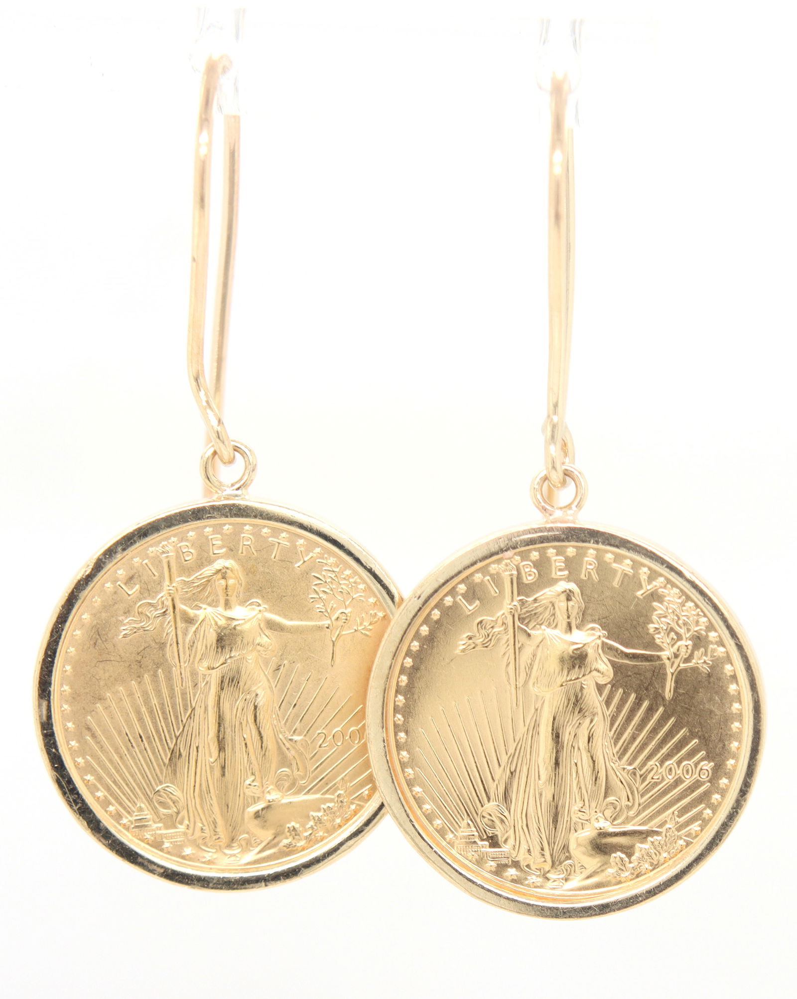 21kt Yellow gold 1/10oz 2006 American eagle gold coin dangle earrings: 21kt Yellow gold 1/10oz 2006 American eagle gold coin dangle earrings. Total weight of earrings is 8.50 grams.