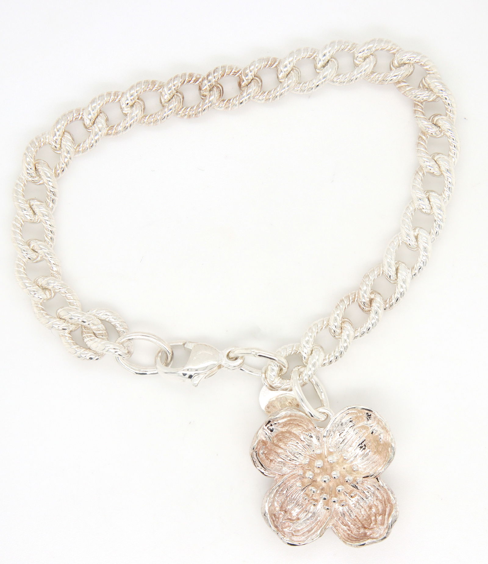 Tiffany & Co dogwood bracelet: 925 sterling silver Tiffany & Co dogwood tag charm 7 inches bracelet. Total weight of bracelet is 26.16 grams.