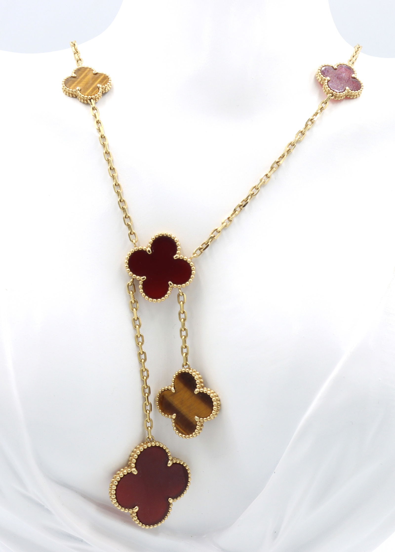 18kt Yellow gold 6 Motif magic Alhambra necklace: 18kt Yellow gold 6 Motif magic Alhambra Carnelian and Tiger's eye quartz slices necklace. Total weight of necklace is 26.9 grams.