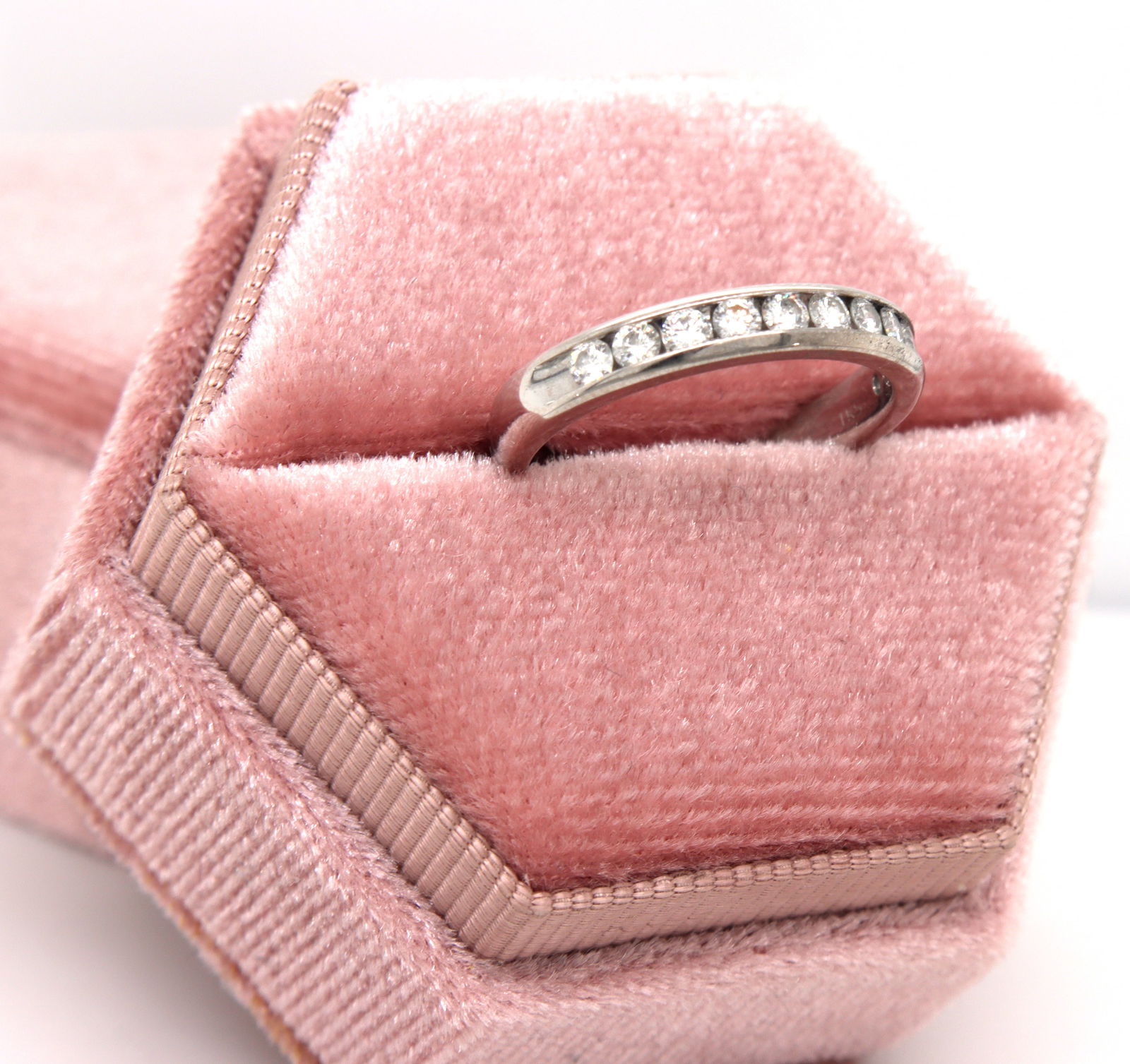 14kt White gold 0.55ctw channel set diamond band: 14kt White gold approximate 0.55ctw channel set diamond band. Color I-J. Clarity SI2. The total weight of the band is 3.50 grams. Ring size 7.25".