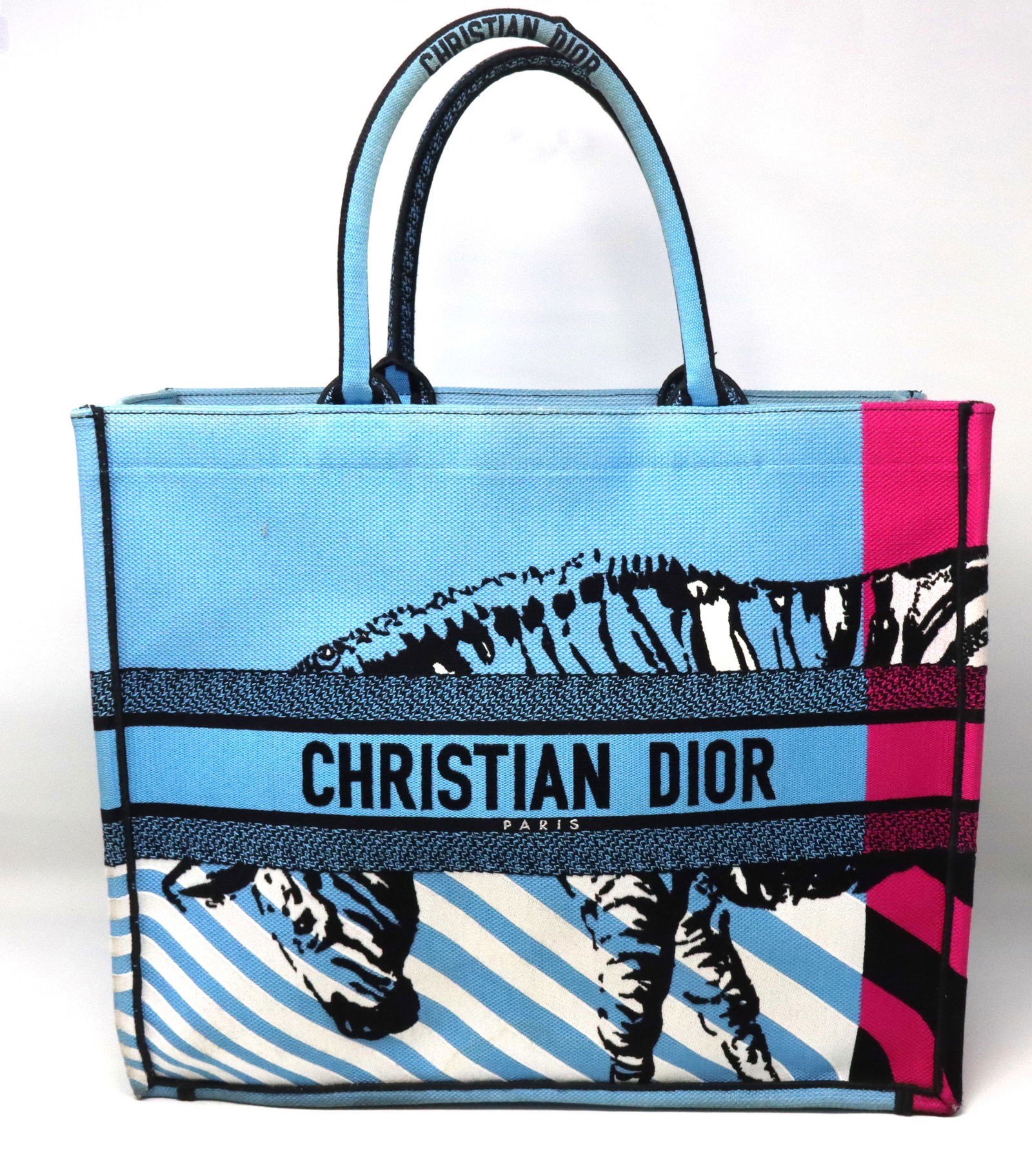 Pre owned Christian Dior medium D jungle pop book tote bag: Pre owned Christian Dior medium D jungle pop book tote blue canvas body bag with rolled top handles. Open top. Made in Italy. Depth 6.49", Width 14.17", Height 10.62", Handle 5.9".