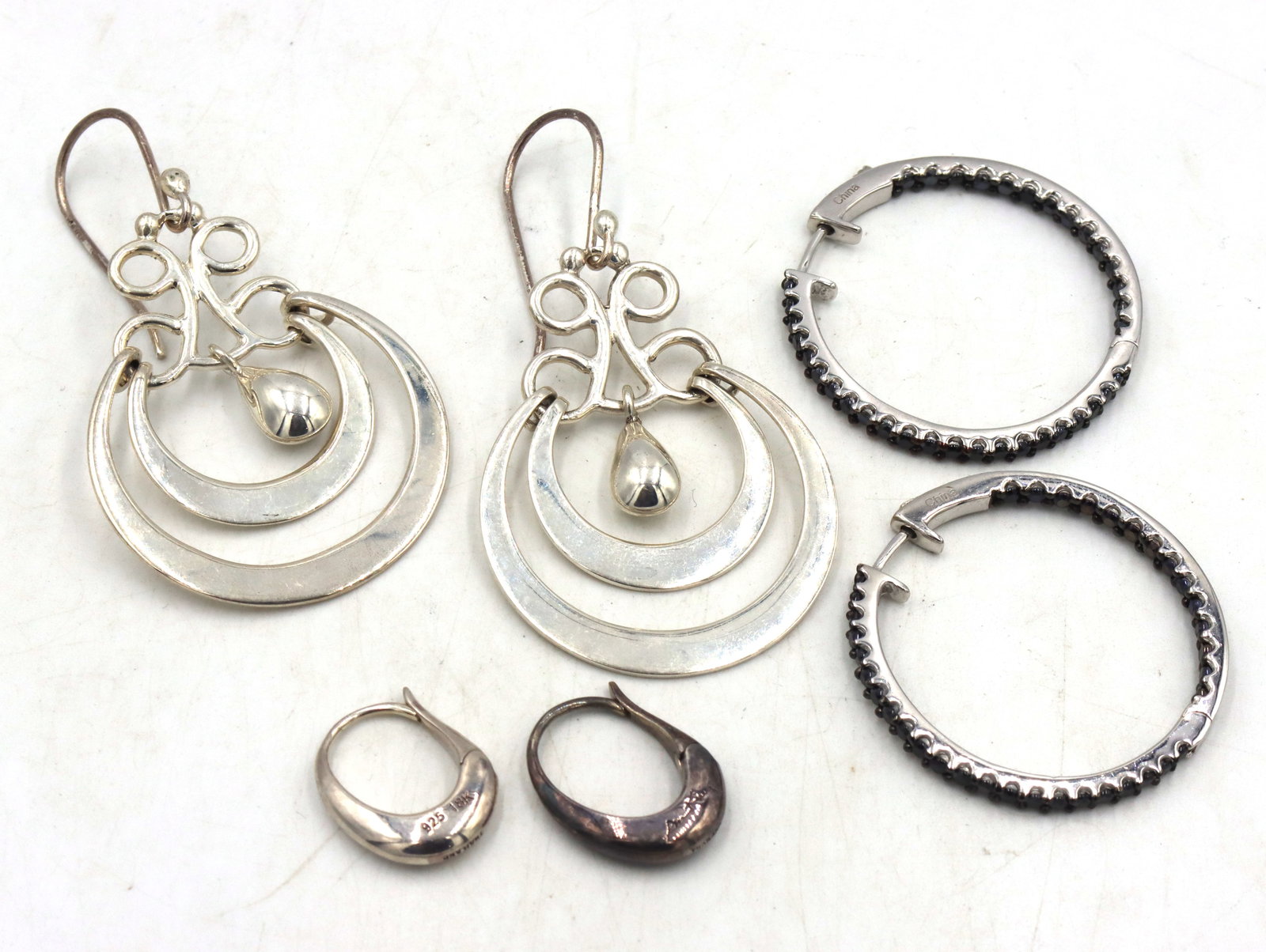 3 Pairs of 925 sterling silver earrings: 3 Pairs of 925 sterling silver earrings. The total weight of the lot is 19.9 grams.