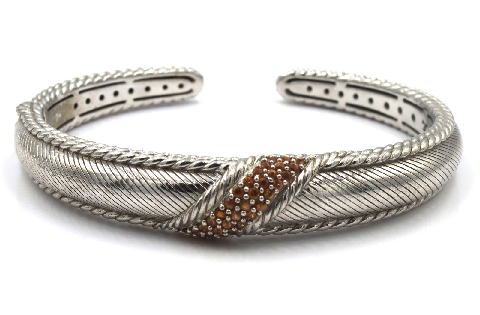 Judith Ripka signed 925 sterling silver orange stone cuff bangle: Judith Ripka signed 925 sterling silver orange stone cuff bangle. The total weight of the bangle is 45.2 grams.