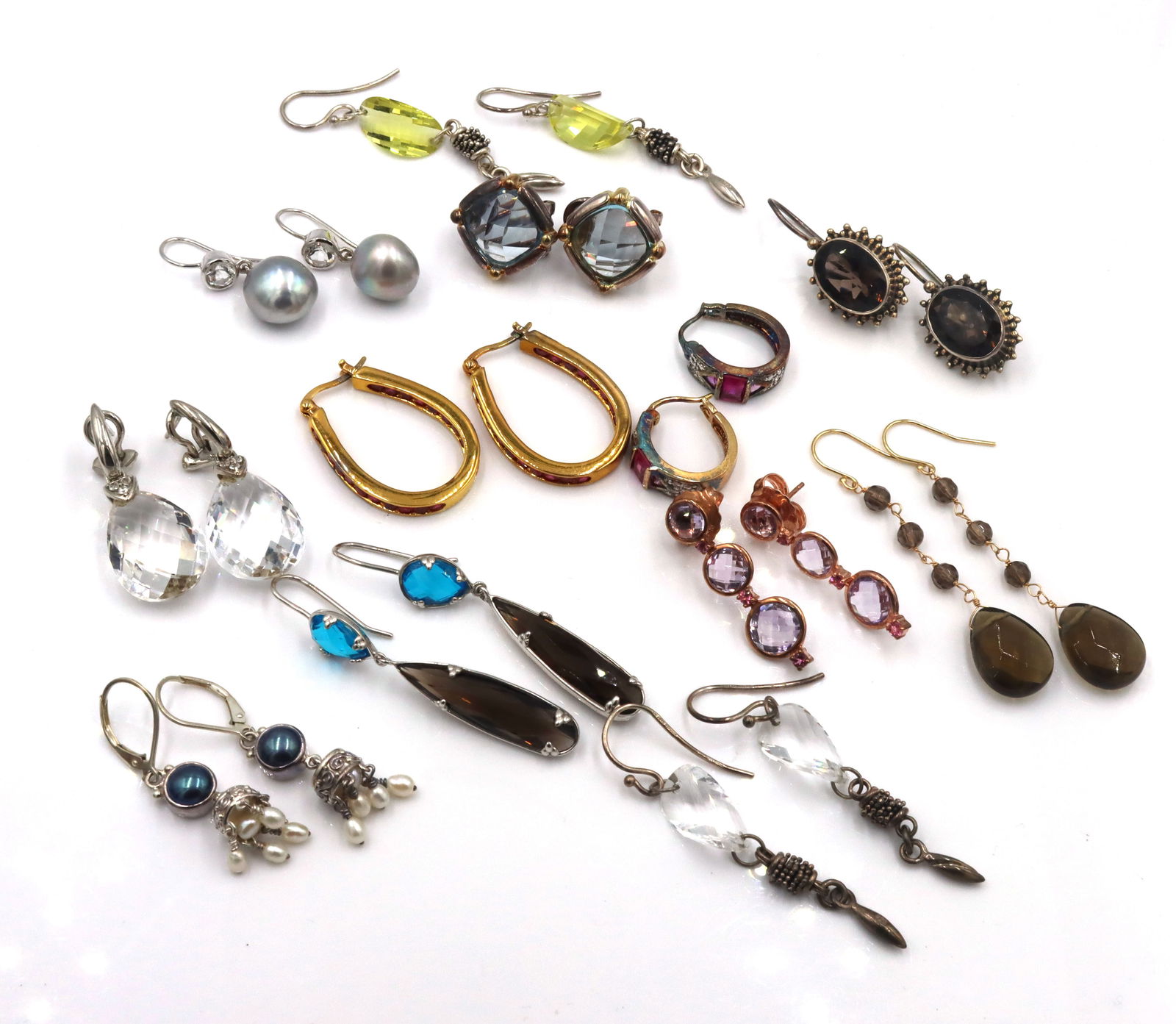 Group lot of Vintage 925 sterling silver earrings: Group lot of 12 pairs of Vintage 925 sterling silver earrings. The total weight of the earrings is 84.5 grams.