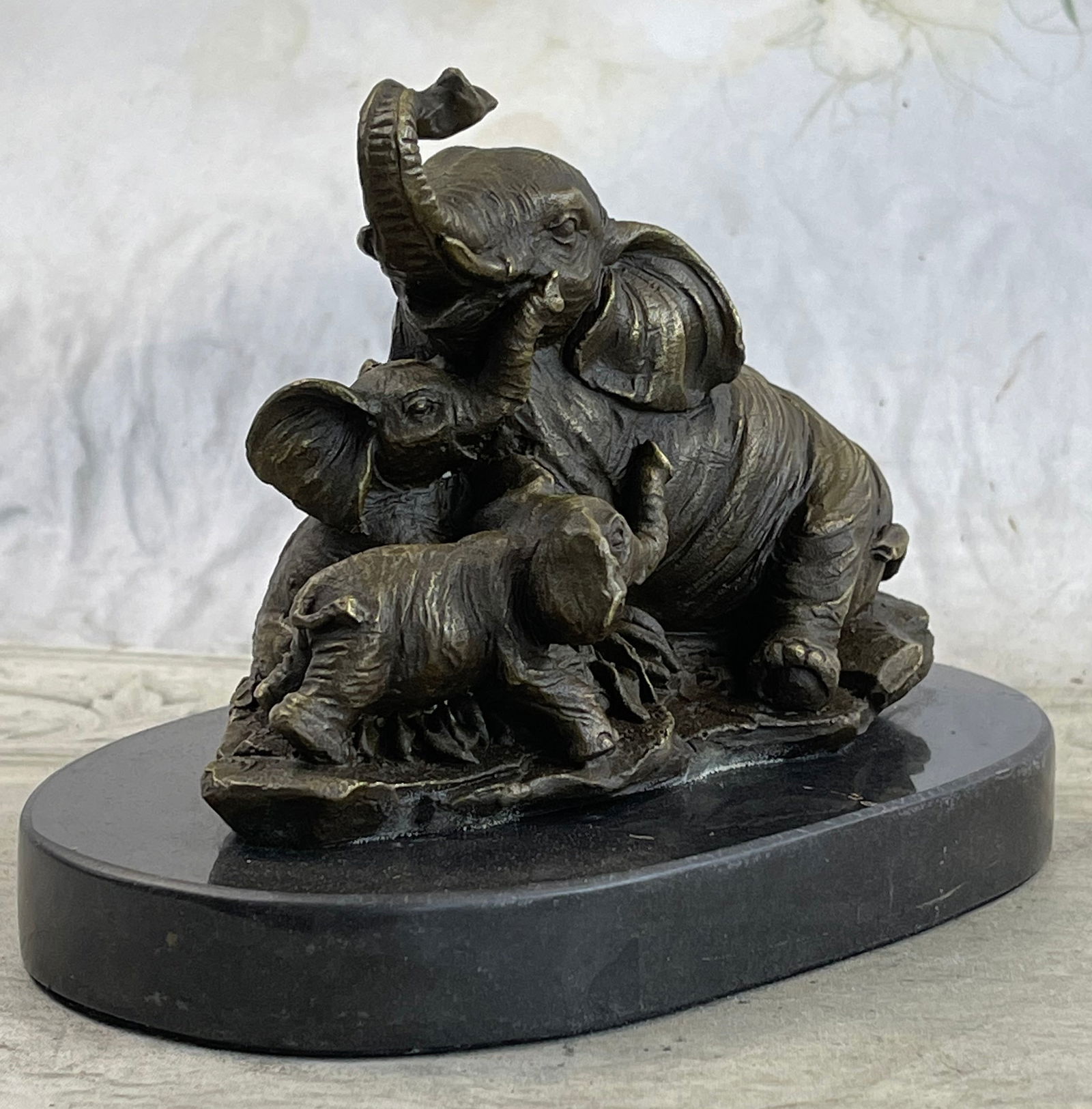 Elephant Mom with Two Cubs Bronze Sculpture: The Elephant Family Celebrates The Unbreakable Bond Between Mother And Child. The Artist Captures A Sweet Moment Between Mother And Child And Uses The Lost-Wax Method To Cast These Figures From Molten