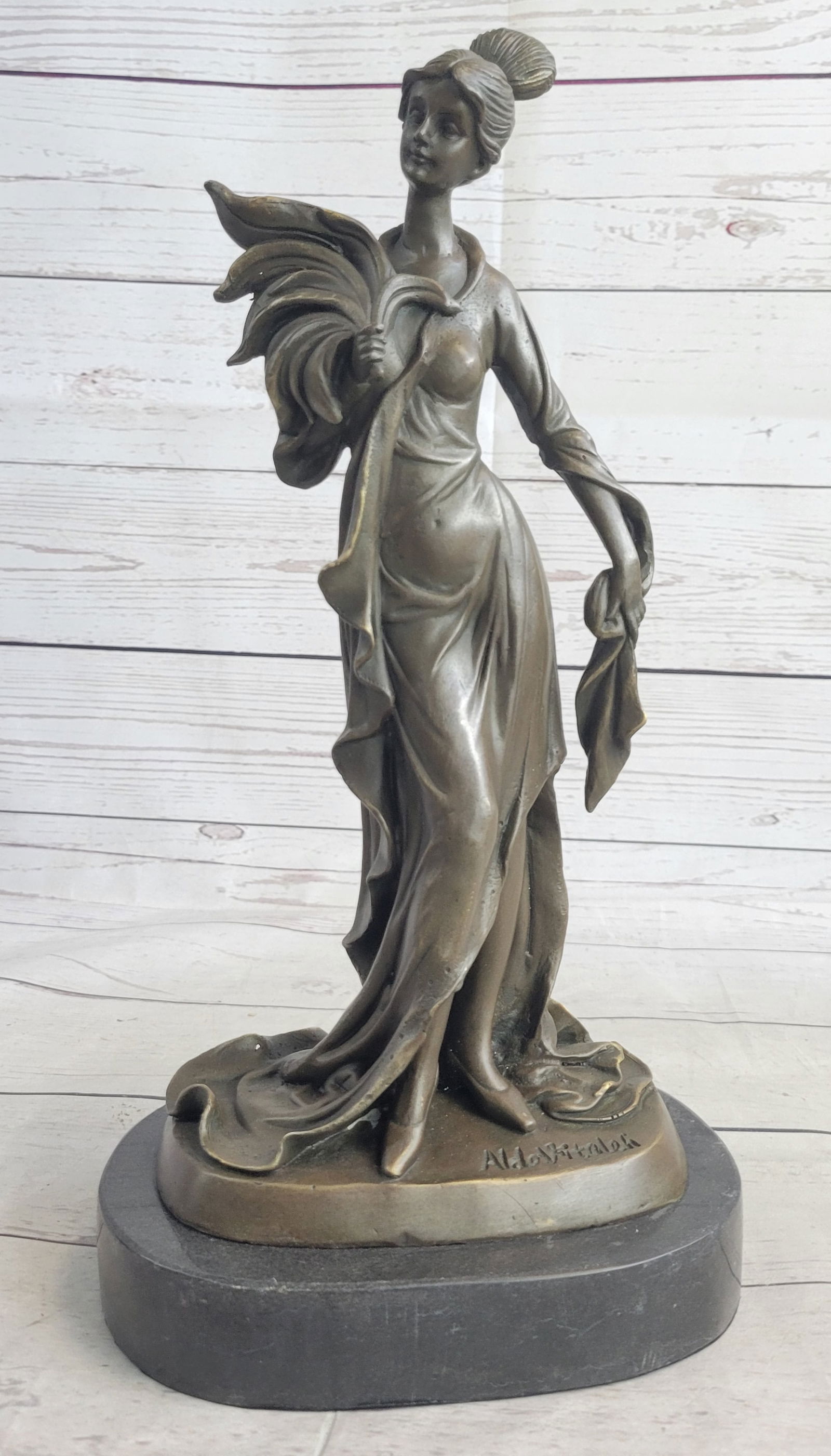 Classical Victorian Woman Bronze Sculpture: The young woman can be imagined walking around her garden in the early morning sunlight exercising her green thumb. Her beautiful dress wraps around her, pulled back by the wind, as her eyes face the