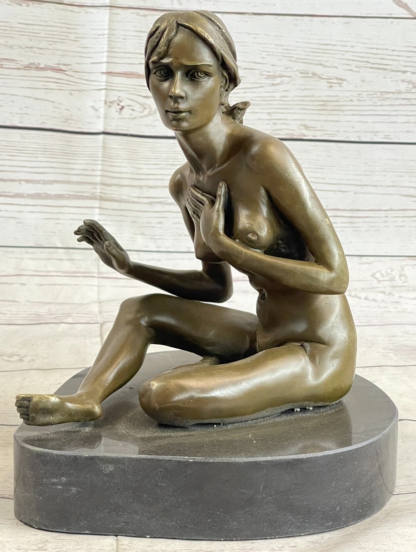 Nude Woman Dancer Bronze Statue: She poses for a painting, sitting before his easel wearing nothing but her curves. She is a natural woman and she sits innocently awaiting his instruction. Her curly hair barely reaches her shoulders.