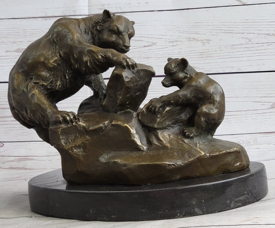 Mother Bear and Cub Bronze Sculpture: The mother bear has taken her young cub to the steep slopes of a mountainside to teach it to forage for a meal. With her powerful foreleg, she pries back a heavy stone, revealing edible moths and grub