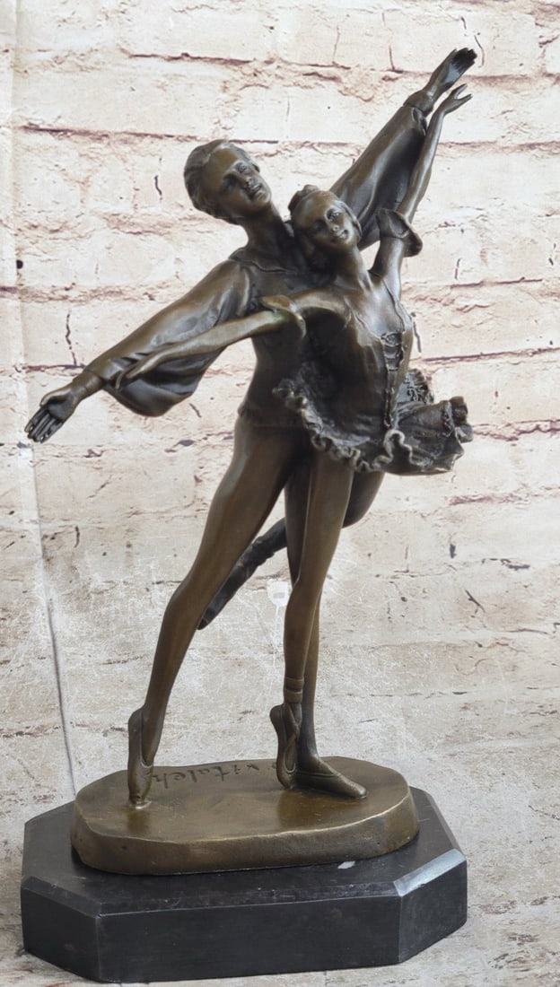 Two Beautiful Ballerina Bronze Sculpture: The bronze ballerina stands balancing all of her gentle weight on her partners, while he supports her on his right leg. She daintily masters her attitude en pointe dance pose as her left leg curves ba