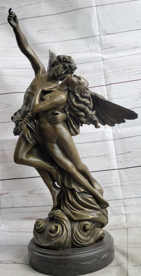 Angel Carries Nude Woman Bronze Sculpture: A physically toned and gorgeous angel carries a nude woman in distress. He has just saved her is transporting her away from trouble. She falls into her protector body. He stares at her with an adoring