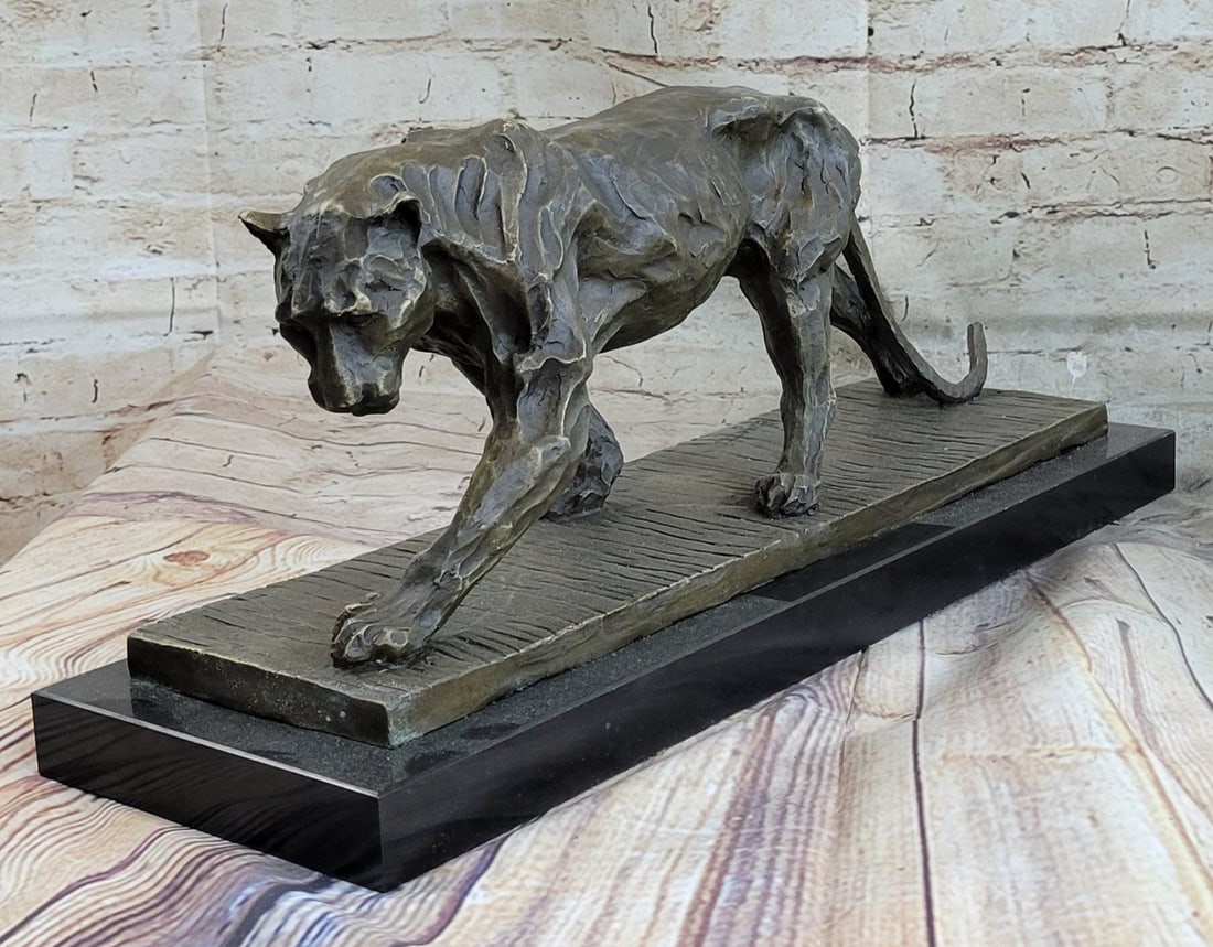 Animal Edition Lion Wildlife Bronze Statue: A lioness wanders through her wild African habitat after chasing away a predator from her cubs. She is fierce yet nurturing, ready to fight to the death to protect herself or her young. The deep carvi