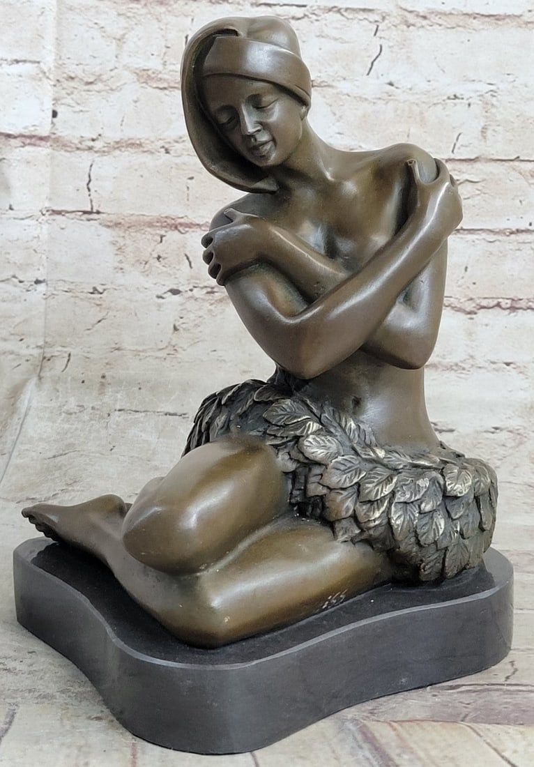 Nude Hawaiian Female on Stone Bronze Sculpture: A female nude on a stone is an extremely delicate Bronze figure, which is suitable as a noble home accessory or piece of art in your office interior. The sensual pose of the young woman draws the view