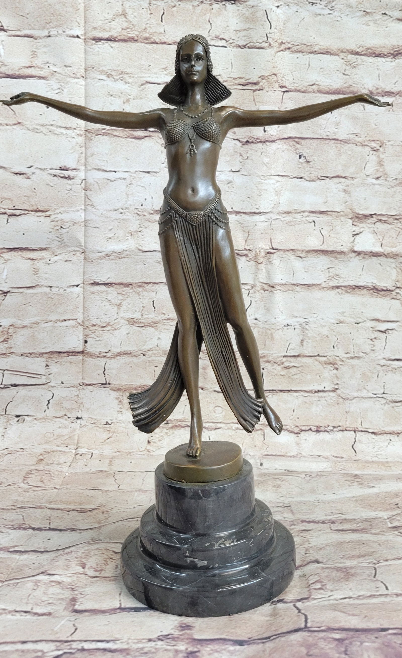 Belly Dancer Bronze Figurine: Her arms are outstretched to her side as she stands on one leg and balances her carefully not to make a mistake during her performance. She has extremely long legs and arms adding to her uniqueness. S
