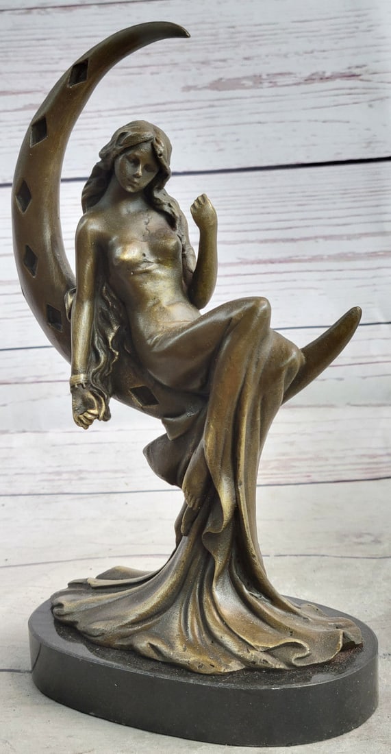 Woman On Moon Bronze Sculpture: The bronze sensual woman sits upward, extending her arms in the air with her legs crossed. Her arms wrap around her head in a grasp of fervor. Her furrowed brow and closed eyes signify her unrelenting