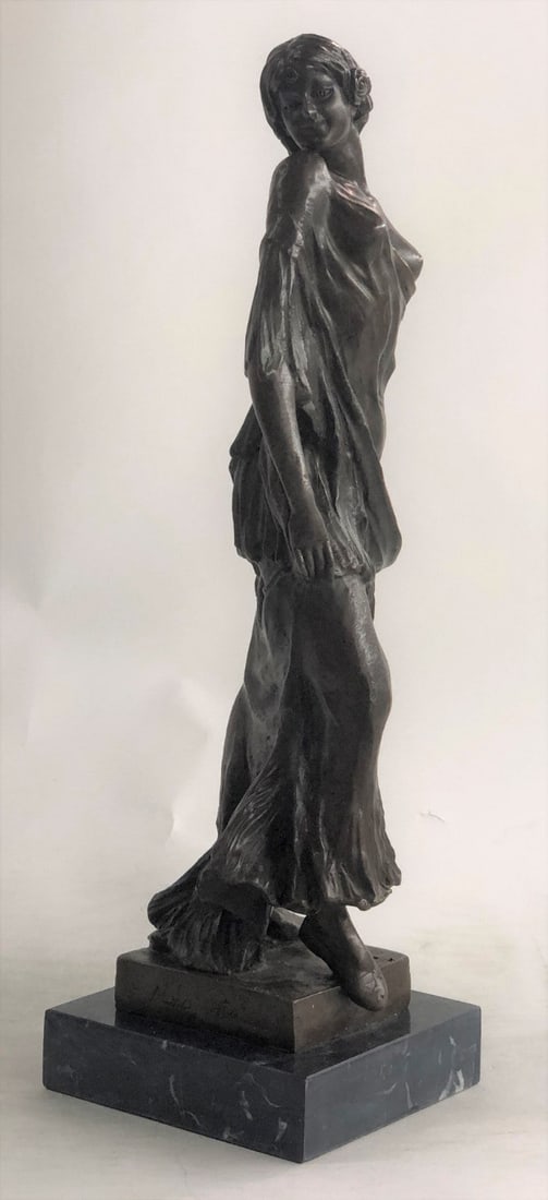 Special Patina Bronze Sculpture: A classic working woman and fashion maven for all times. She stands with pride and elegance. She wears a long ruffled dress and exposing one breast. A small flower decorates her hair. She turns her he