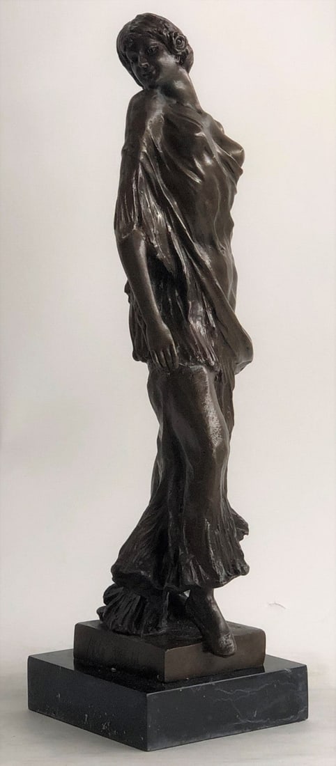 Lady Model Bronze Sculpture: A classic working woman and fashion maven for all times. She stands with pride and elegance. She wears a long ruffled dress and exposes one breast. A small flower decorates her hair. She turns her hea