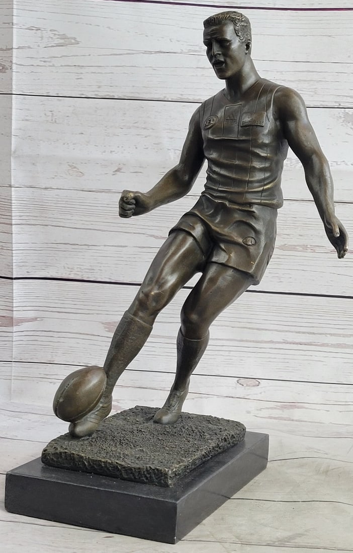 Muscular Rugby Player Bronze Sculpture: A muscular Rugby player runs for the end field, trying to skip the yards and avoid being tackled. His powerful legs ache as he sprints and dodges. He Kicked the ball under him protectively. Every once