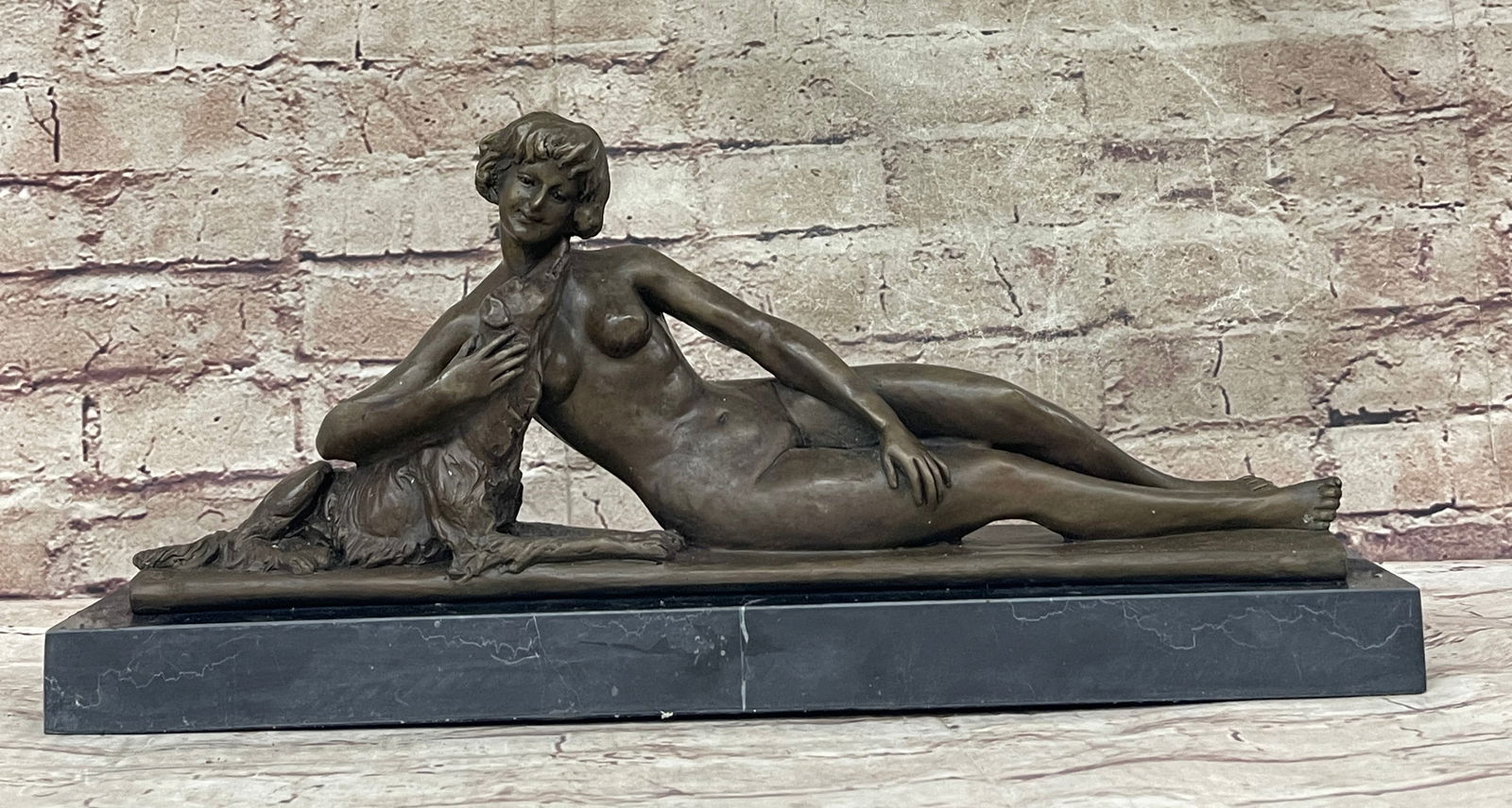 Young Woman With Dog Bronze Sculpture: Refined and sophisticated, this classy woman lays in a comfortable and relaxed position. She places her arm behind her beautiful dog, like an innocent child. Her hair is short and she is fully nude. S