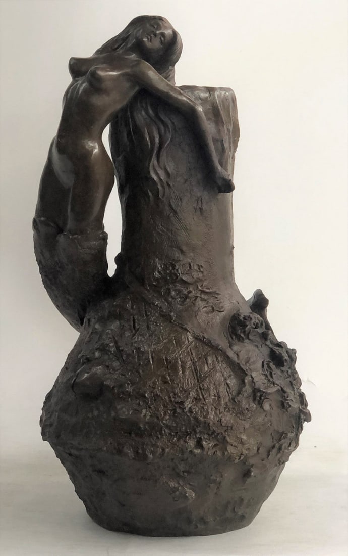 Mermaid Vase Bronze Sculpture Statue: This is an oval base shape and a very decorative art nouveau handle in the form of a mermaid. The vase has a decorative design and the spout has a fish design. The handles depict a mermaid sitting und