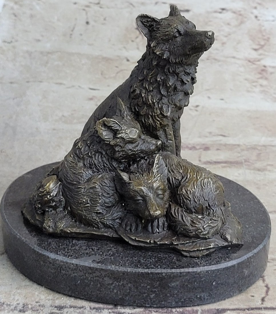 Miniature Wolf Family Bronze Sculpture: The wolf mother and cubs can be imagined to be seen, masked by the falling snowflakes, sitting among the rocks of the entrance of their den. The mother lays exhibiting her patience as one of her offsp