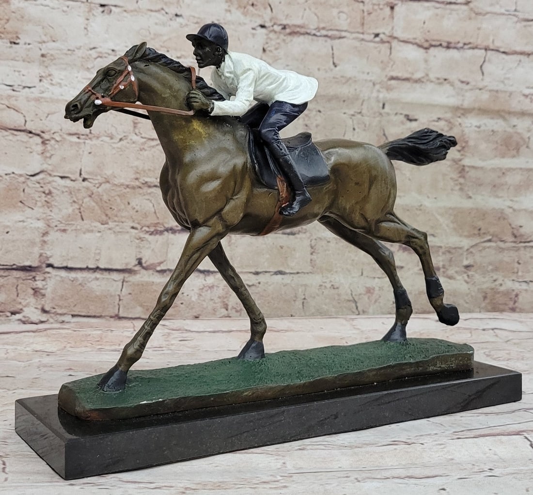 Jockey Riding Horse Bronze Statue: Running on a grass track this horse refuses to lose this derby. He exerts full speed as he pushes against the wind, his tail fly back with force, as the jockey encourages his partner to go full speed