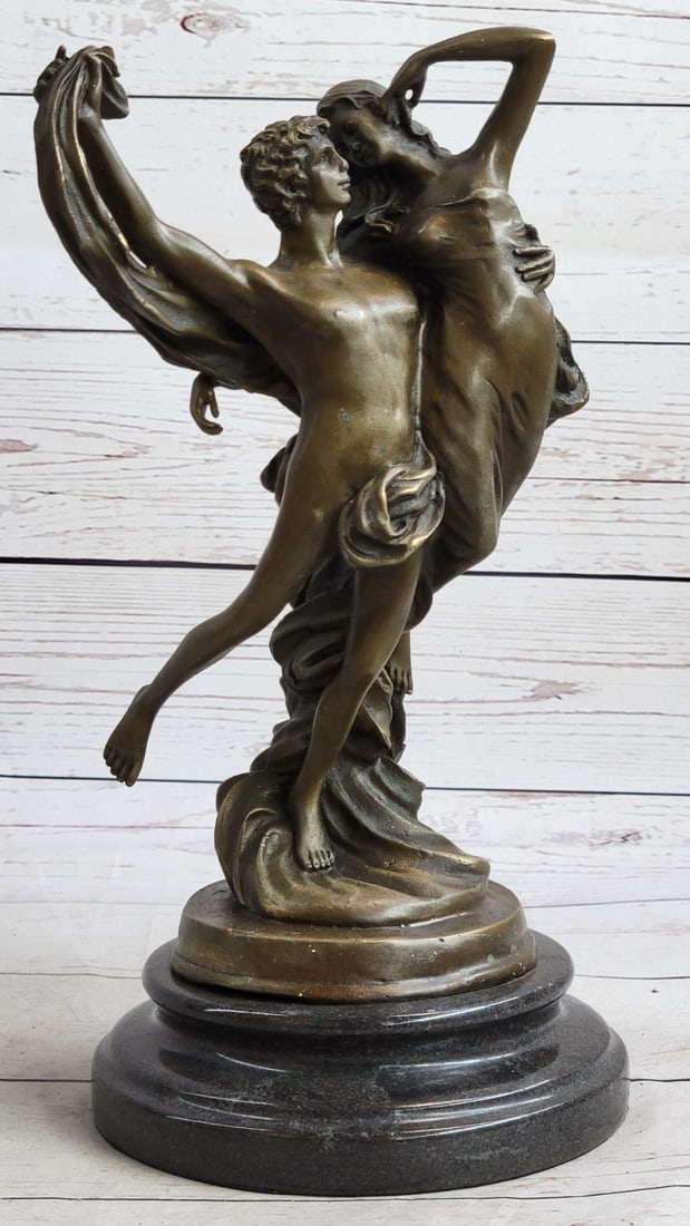Marioton Couple Dance Bronze Sculpture: Lost in a moment of serenity and grace this couple forgets the worlds and gets swept up in the winds of love and lets an uncontrollable storm of emotion take the lead. She wears a long slim-fitting dr