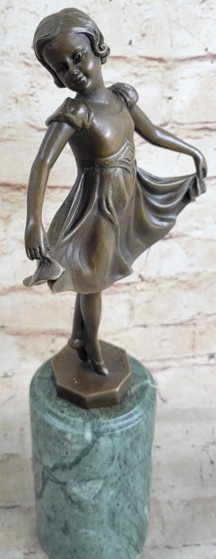 Little Ballerina Dancer Bronze Sculpture: She shows off her agility, balance, and flexibility. She elevates her long leg far behind her. Her chest pushes out and her head tips up to the sky, basking in the glory of being center stage. Her spi