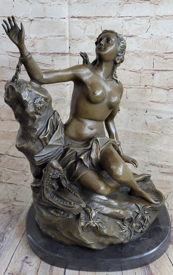 Nude Nymph Bronze Sculpture: The village goddess has been captured, imprisoned and offered up as a human sacrifice. She was stranded out on a cliff and chained to a rock. An amputated boars head sits beside her, an additional sac
