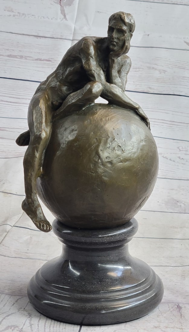 Nude Male Resting on Top of the World Bronze Sculpture: This amazing sculpture art piece of a male sitting on top of the world the way he came to it, nude. As he holds his head up with his left hand he slouches over leaning on his left elbow and putting fu