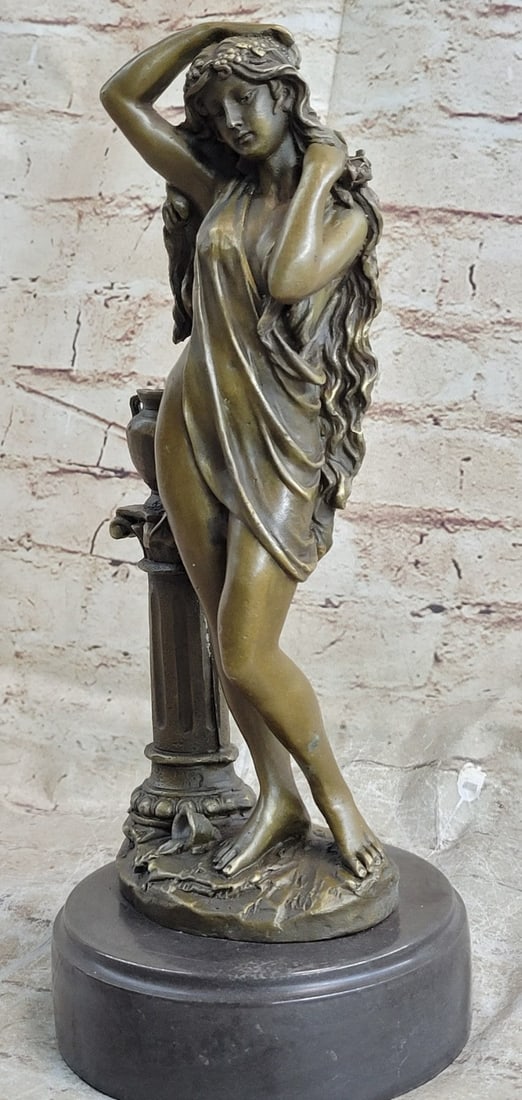 Female Figure Bronze Statue: The bronze maiden, in a contrapposto position, is found pushing away her flowing locks from her delicate face, as she pulls the enchanted beholder to stare and stare at her. There is something magneti