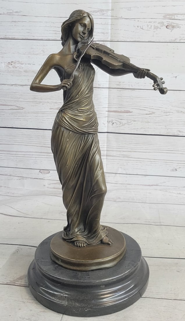 Violin Player Bronze Sculpture: Peacefully entranced by her musical gift, this woman plays her violin. Her eyes are closed as she moves the bow back and forth creating beautiful delicate music. Her long hair lays down her back, on i