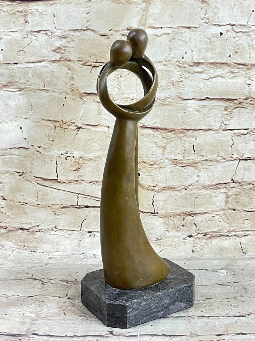 Male and Female Kissing Bronze Sculpture Marble Base Figurine: An abstract creation portraying two beings becoming one. The piece takes on the shape of the infinity symbol suggesting an eternal unity between the two. This one-hundred percent bronze sculpture will