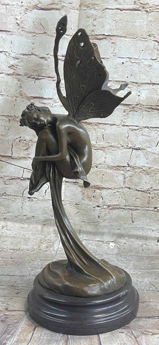 Fairy Fantasy Winged Bronze Sculpture: A Fairy Flies from Heaven. She hails from the heavens and fights for the salvation of our world as well as his from darkness of any form. She wears a robe and sandals, carrying a message with her wing